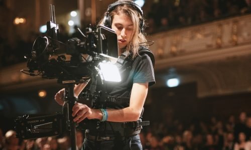 woman in black t-shirt holding black video camera